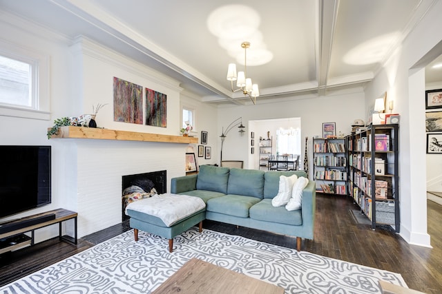 living area with beam ceiling, a fireplace, a notable chandelier, ornamental molding, and wood finished floors