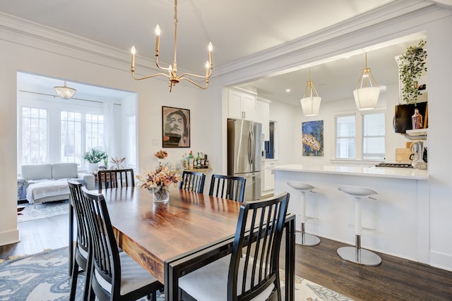 dining area with dark wood-style floors and ornamental molding