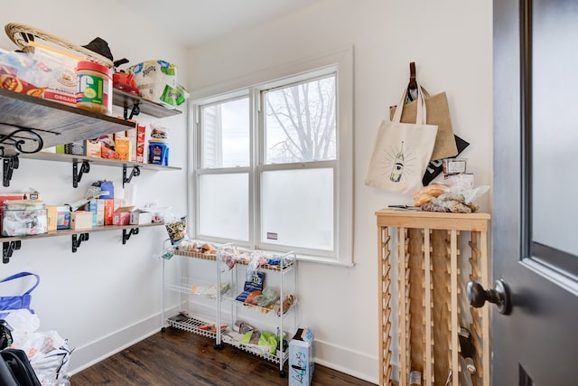 laundry room with baseboards and wood finished floors