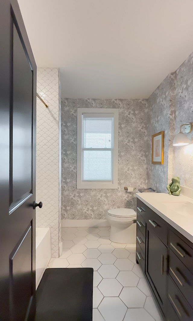 bathroom with shower / bath combination, wallpapered walls, toilet, tile patterned floors, and vanity