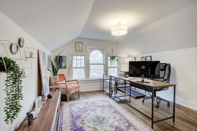 office space with lofted ceiling, baseboards, and wood finished floors