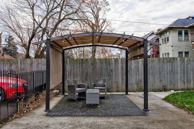 view of patio / terrace with a fenced backyard, a pergola, and a detached carport