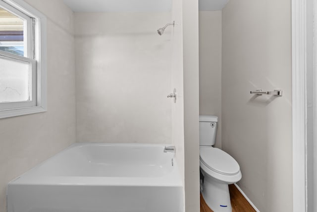 bathroom featuring a tub and toilet