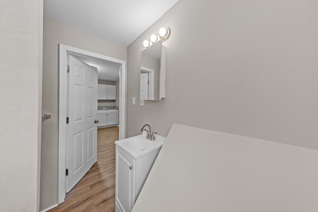 bathroom with vanity and wood finished floors