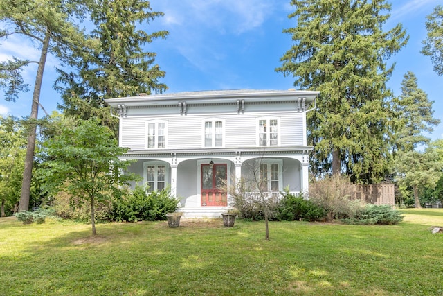 view of front of property with covered porch and a front lawn