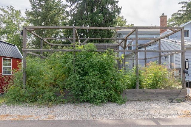 exterior space with a garden and metal roof