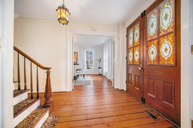 entryway with stairway, visible vents, and light wood-style flooring