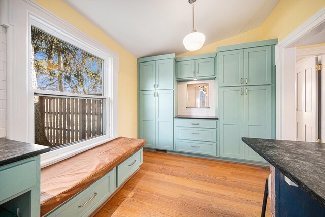 mudroom featuring vaulted ceiling and light wood finished floors