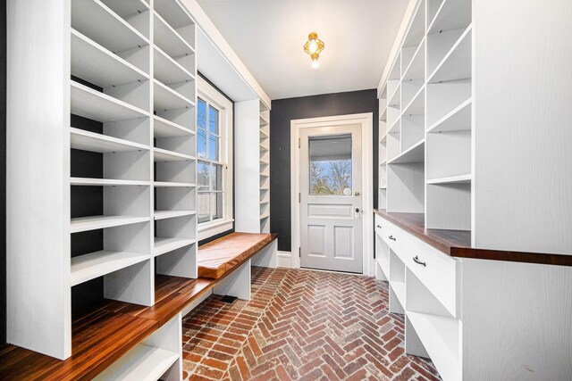 mudroom with brick floor