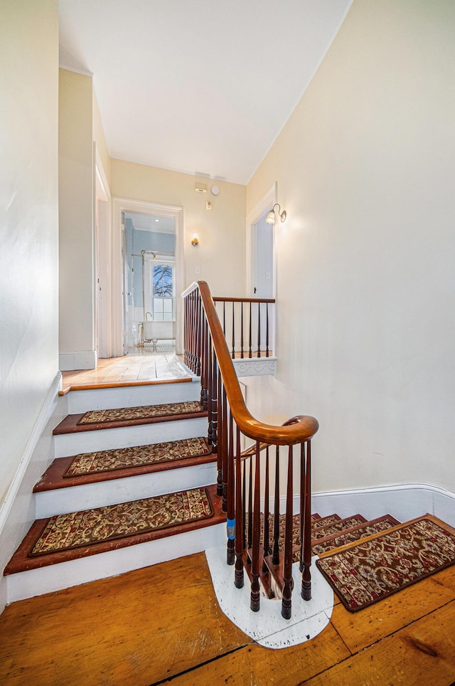 staircase featuring baseboards