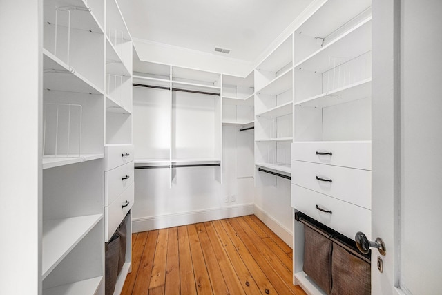 spacious closet featuring light wood-style floors and visible vents