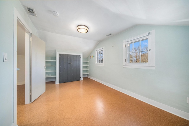 bonus room featuring vaulted ceiling, light floors, visible vents, and baseboards