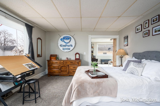 bedroom with a drop ceiling and carpet flooring