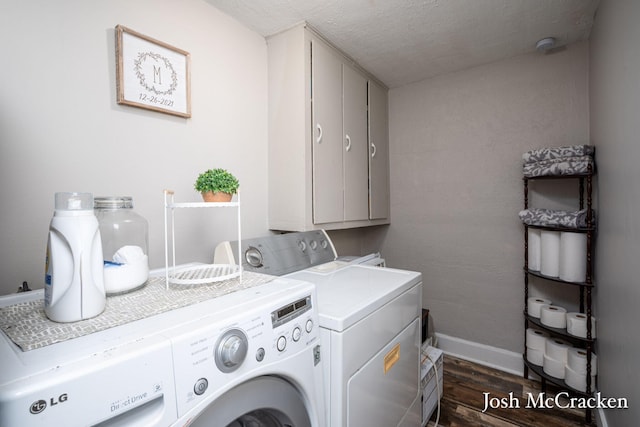 washroom featuring a textured ceiling, separate washer and dryer, baseboards, cabinet space, and dark wood finished floors