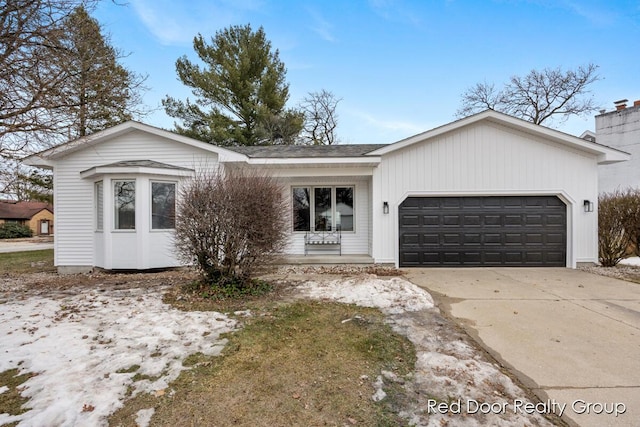 ranch-style house with a garage and driveway