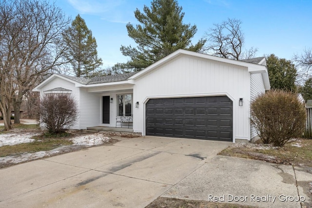 ranch-style house with driveway, a porch, roof with shingles, and an attached garage