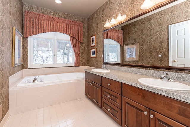 bathroom featuring double vanity, a sink, a bath, and wallpapered walls