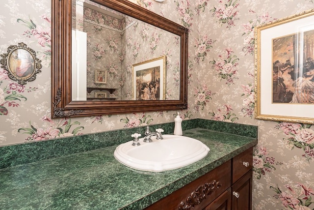 bathroom featuring vanity and wallpapered walls