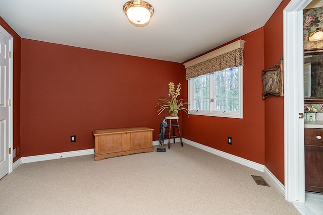 carpeted empty room featuring visible vents and baseboards