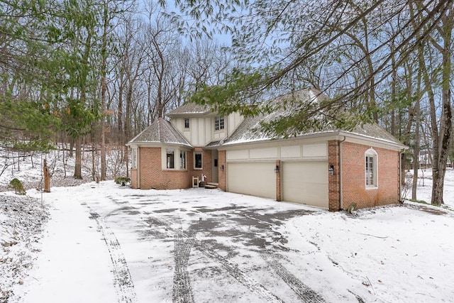 view of front of property featuring brick siding and an attached garage