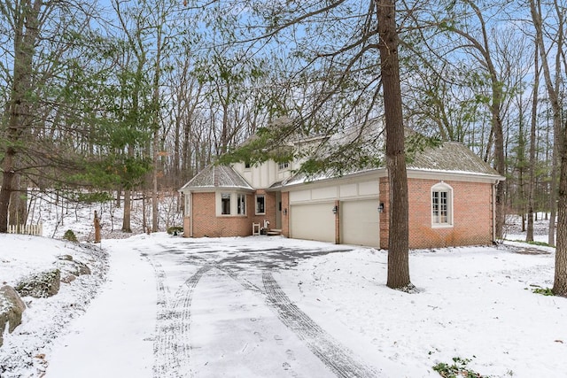 single story home with a garage and brick siding