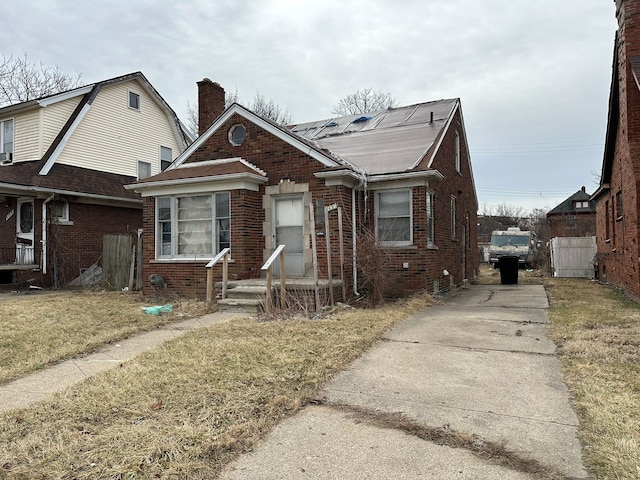 bungalow with brick siding and driveway