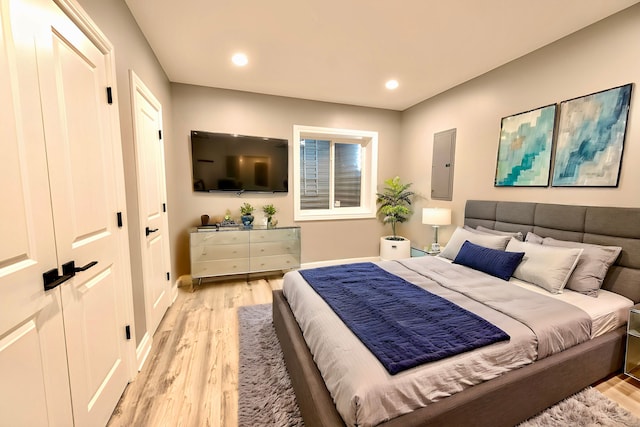 bedroom with baseboards, light wood-style floors, and recessed lighting