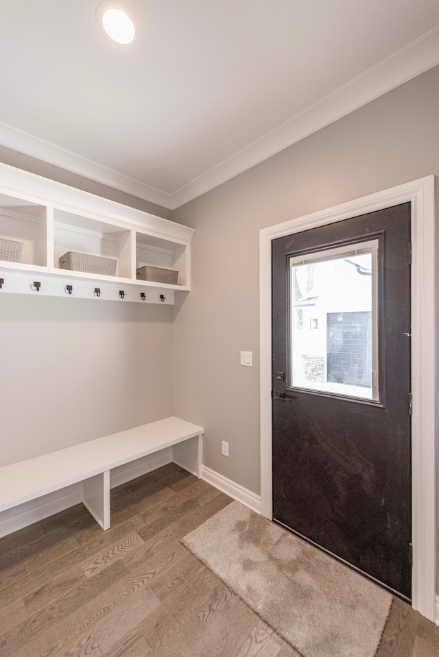 mudroom featuring baseboards, wood finished floors, and crown molding