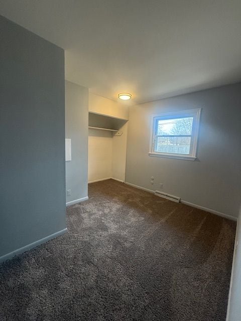 unfurnished bedroom with carpet floors and baseboards