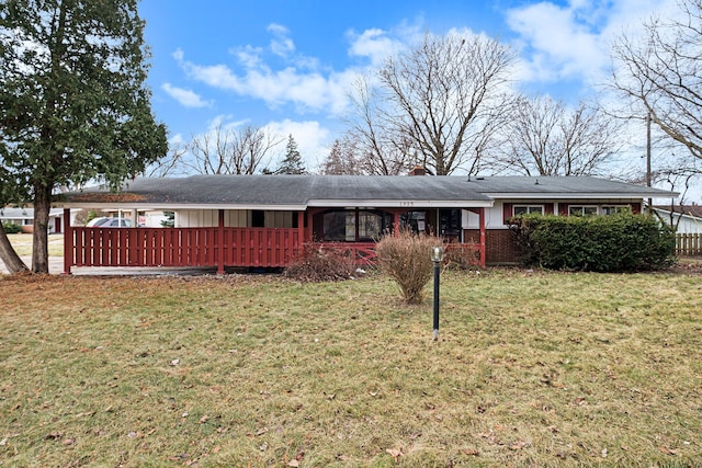 ranch-style house featuring a front lawn, a chimney, and brick siding