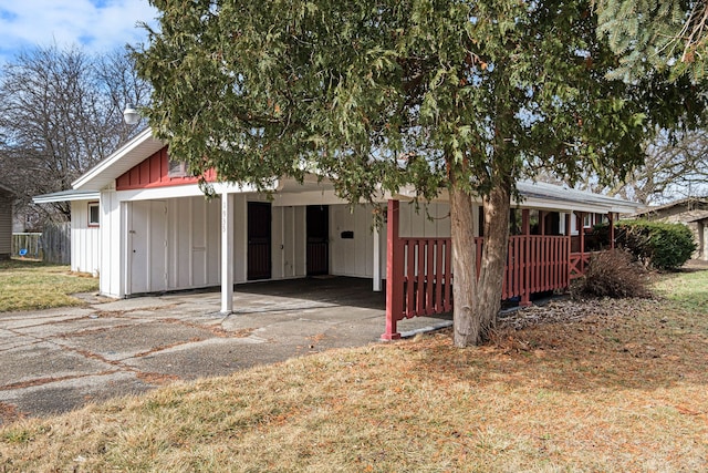 view of front facade featuring an attached carport and board and batten siding