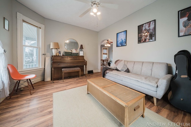 living room with light wood-style floors and a ceiling fan