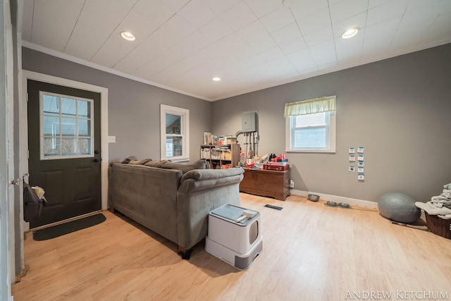 living area featuring ornamental molding, light wood-type flooring, baseboards, and recessed lighting