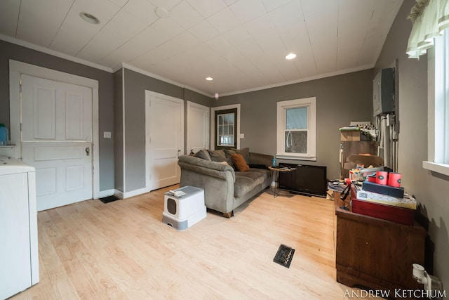 living room with washer / dryer, baseboards, crown molding, light wood-style floors, and recessed lighting