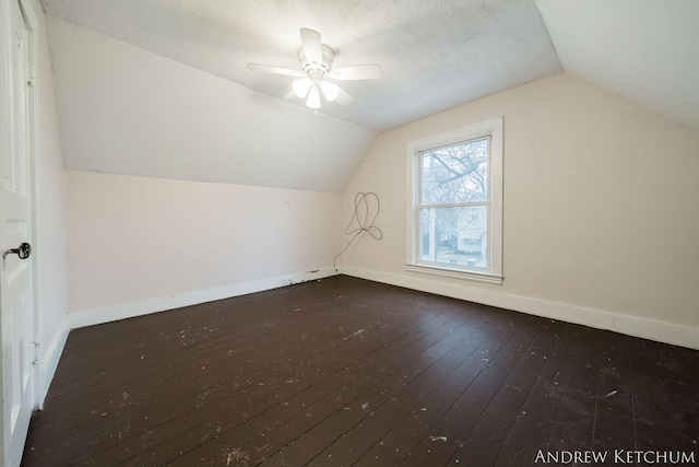 bonus room with lofted ceiling, wood-type flooring, a ceiling fan, and baseboards