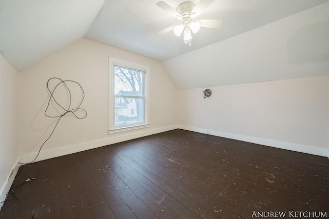 bonus room featuring baseboards, vaulted ceiling, hardwood / wood-style floors, and ceiling fan