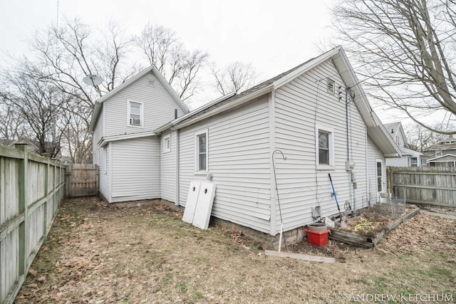 back of house with a fenced backyard