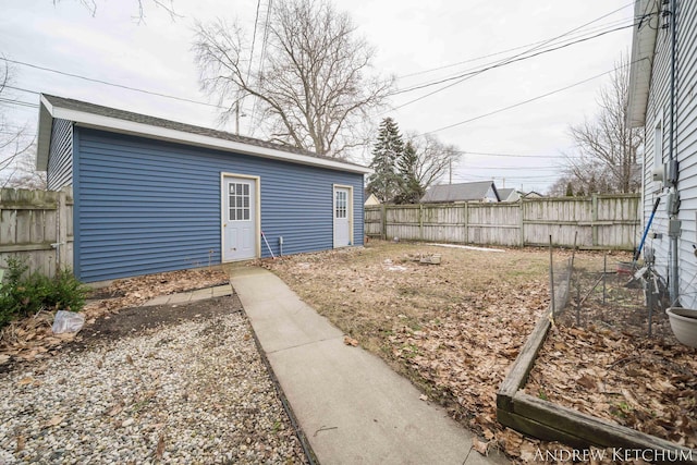 exterior space featuring fence and an outdoor structure