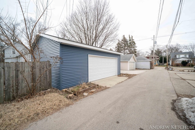 detached garage featuring fence