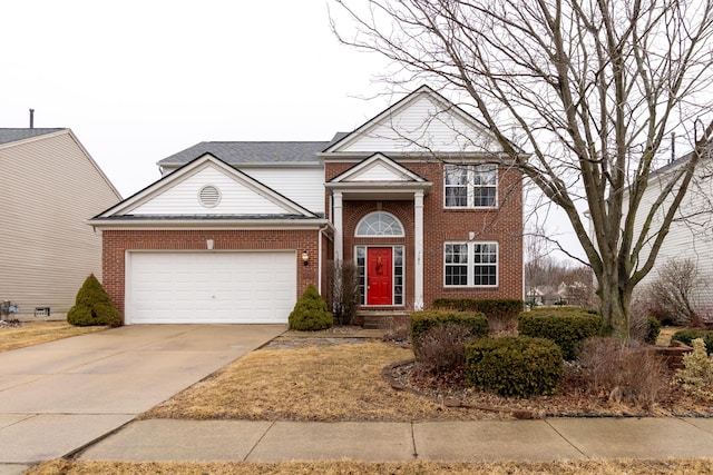 traditional-style house with a garage, brick siding, and driveway