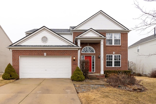 traditional home with a garage, concrete driveway, and brick siding