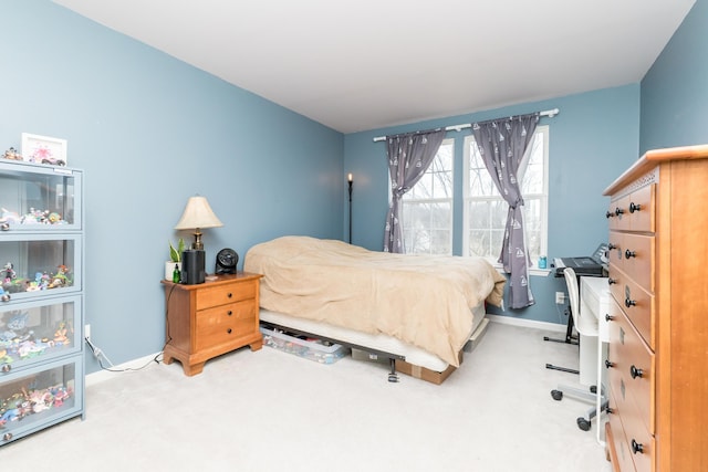 carpeted bedroom with baseboards