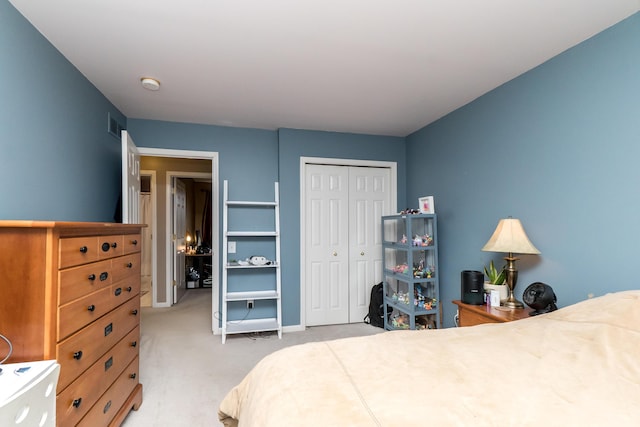 bedroom featuring baseboards, a closet, visible vents, and light colored carpet