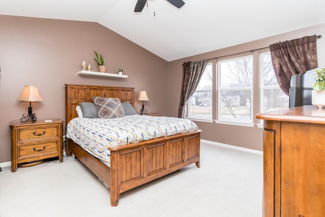 bedroom with vaulted ceiling, baseboards, a ceiling fan, and light colored carpet