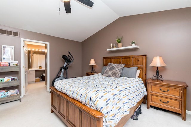 bedroom featuring light colored carpet, visible vents, ensuite bathroom, ceiling fan, and vaulted ceiling