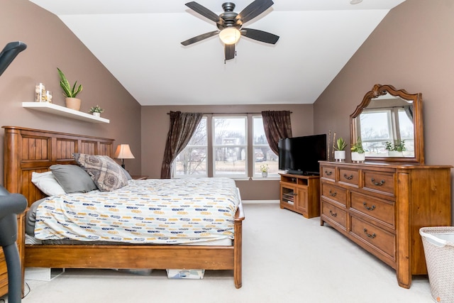 bedroom with light carpet, baseboards, vaulted ceiling, and a ceiling fan