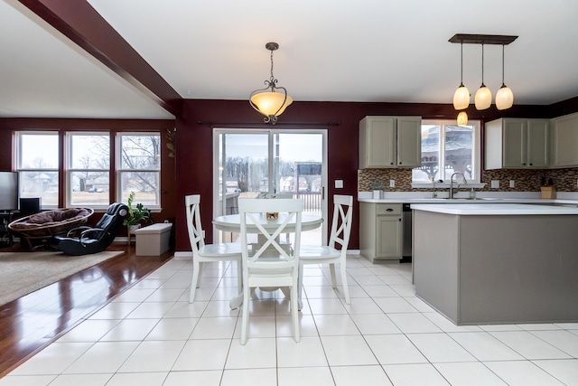 kitchen with tasteful backsplash, light countertops, a wealth of natural light, and gray cabinetry