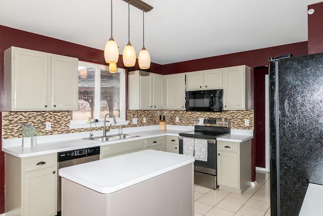 kitchen with decorative backsplash, a center island, light countertops, black appliances, and a sink