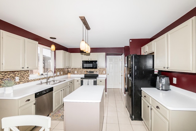 kitchen featuring decorative backsplash, a kitchen island, light countertops, black appliances, and a sink