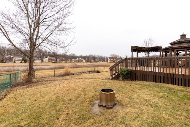 view of yard with a deck, a gazebo, and fence